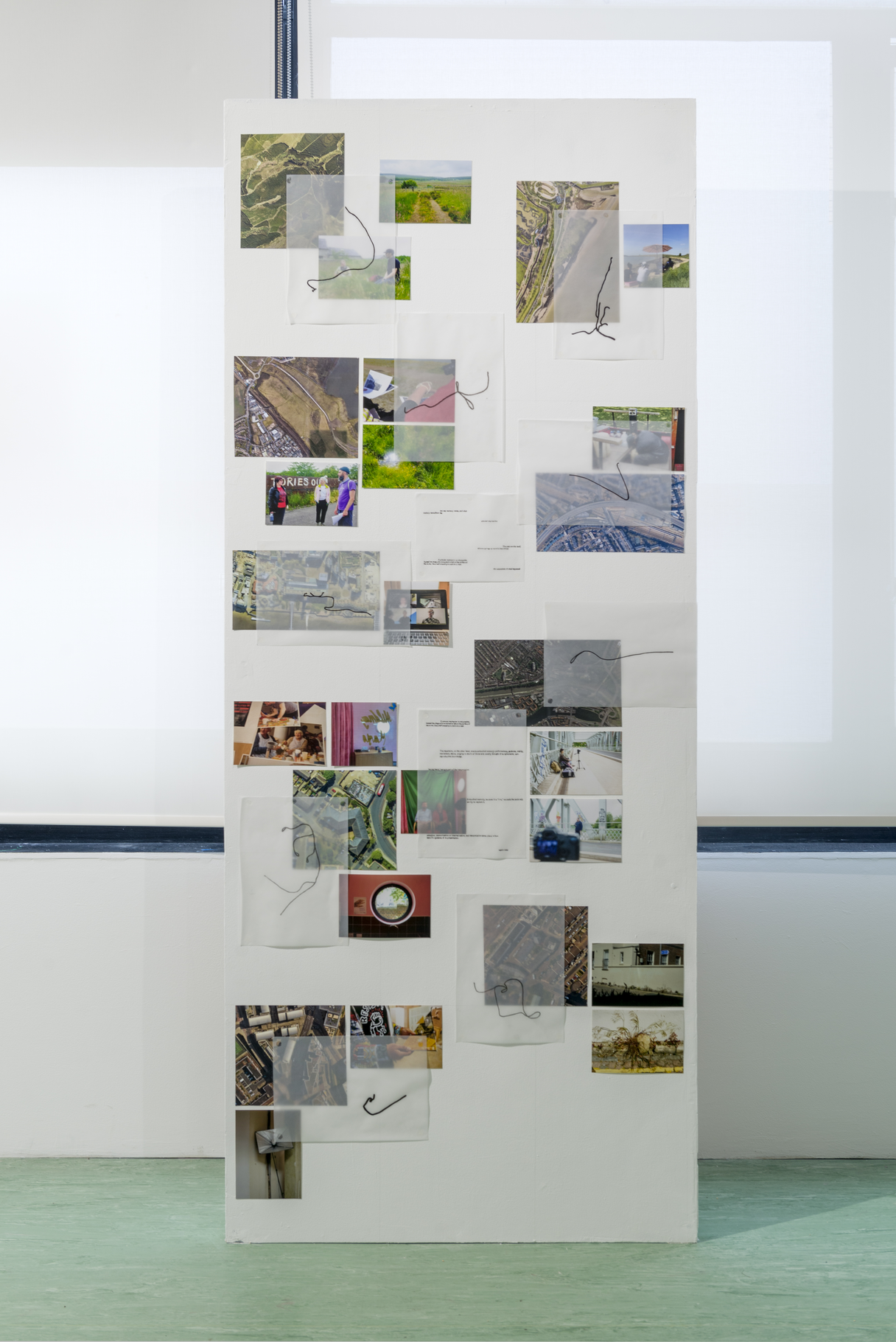 A wall of images, texts, maps and shapes scattered.