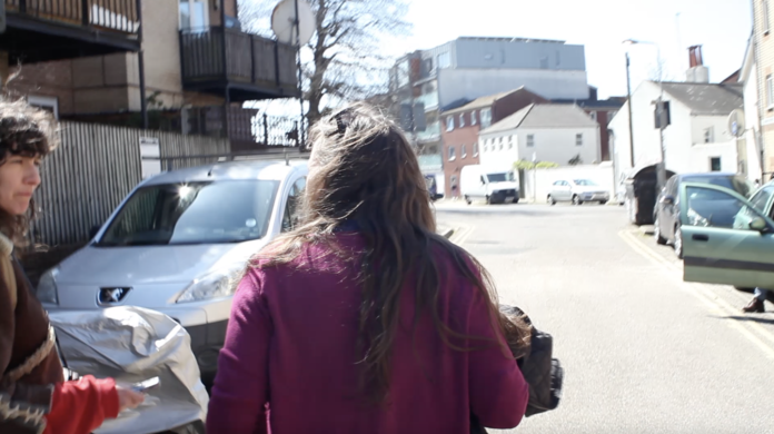 A photo of two woman walking down a street.