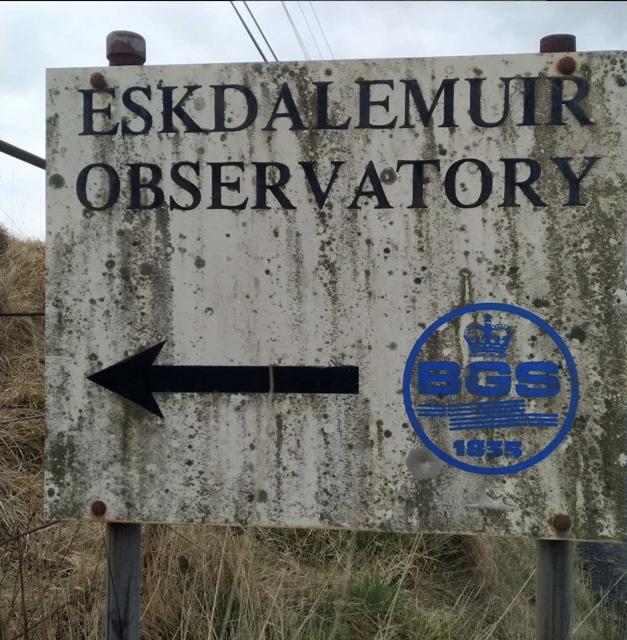 This photograph depicts a closeup of the sign indicating the location of the Eskdalemuir Observatory.