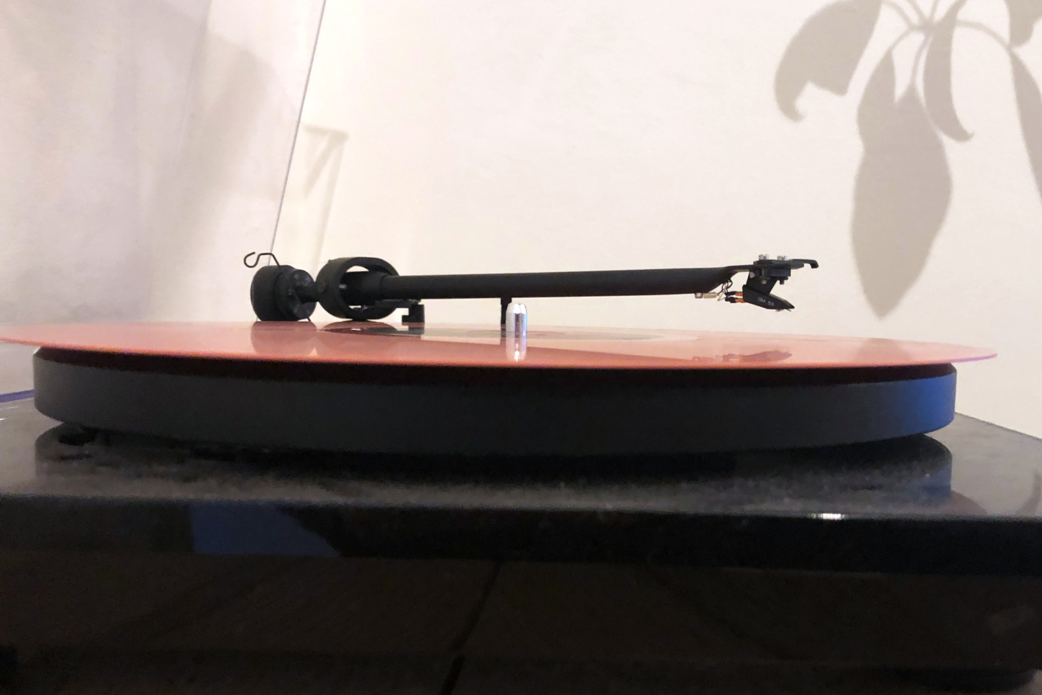 Picture of a turntable with a pink LP on it.