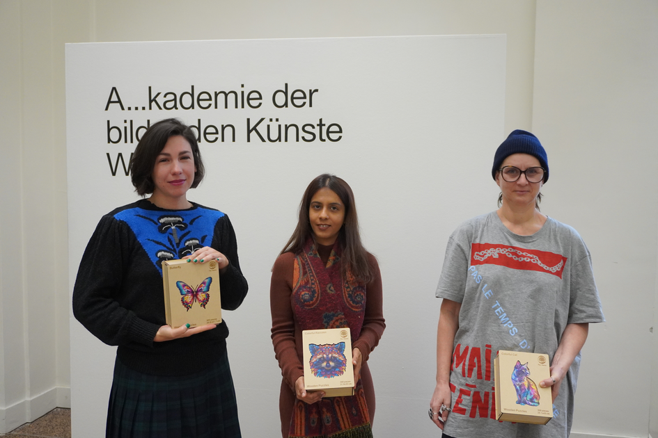 The RC prize winners Ana de Almeida, Zahra Khalid Mirza and Ingrid Cogne holding colourful animal puzzles as their award trophies.