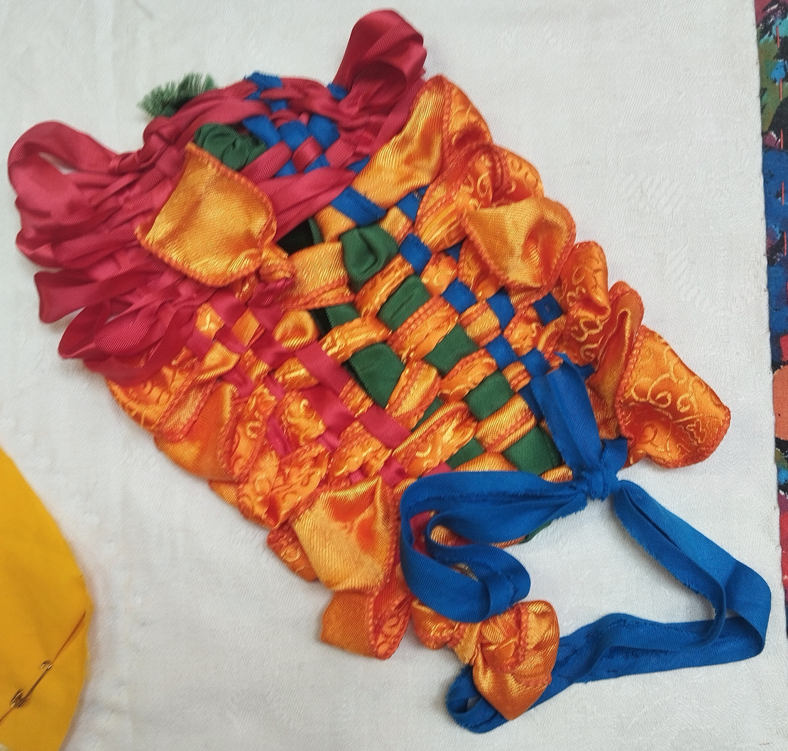 bright weaving with orange ribbon and blue fabric