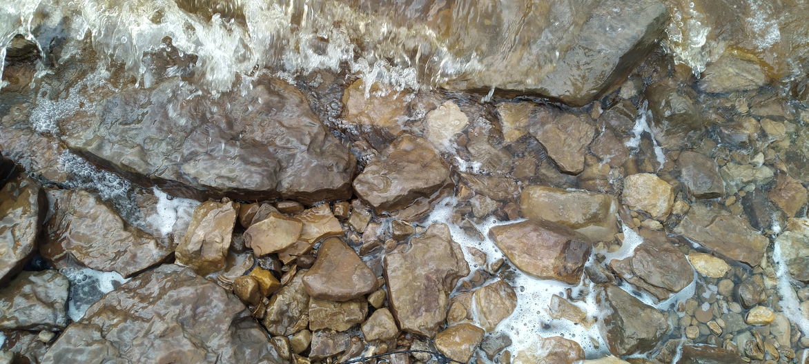 A photo displaying a curve at the meeting at the nebulous boundary of land and water. This and each subsequent photo show how the curves become more complex at each order of magnitude of magnification. Meanwhile, the notion of where land ends and water begins also increases in complexity.