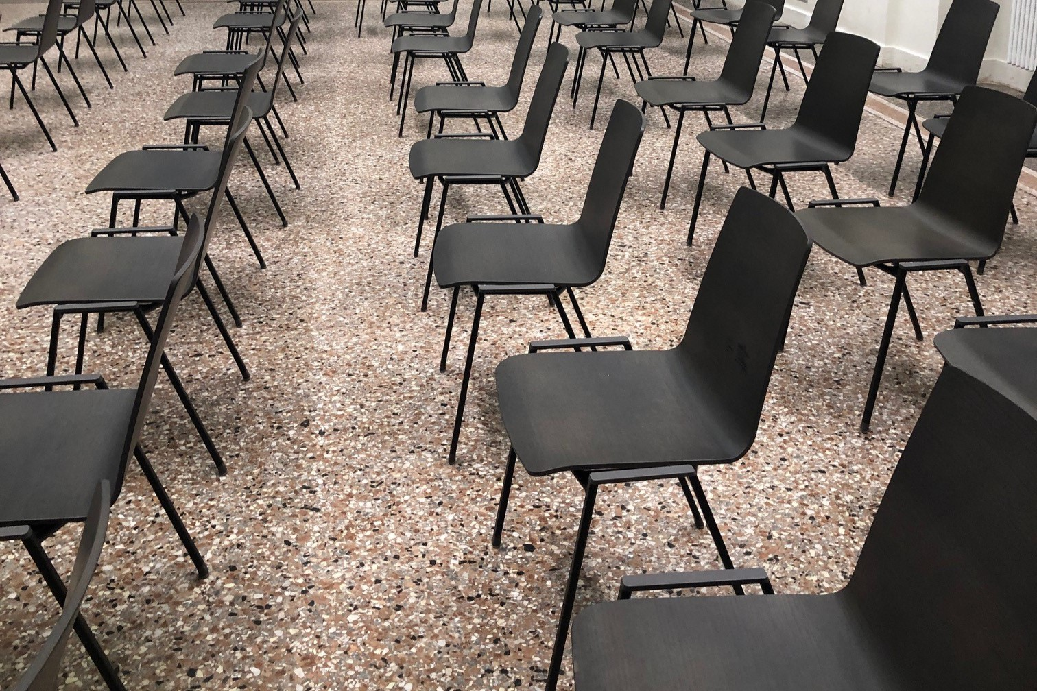 Rows of chairs in a big room.