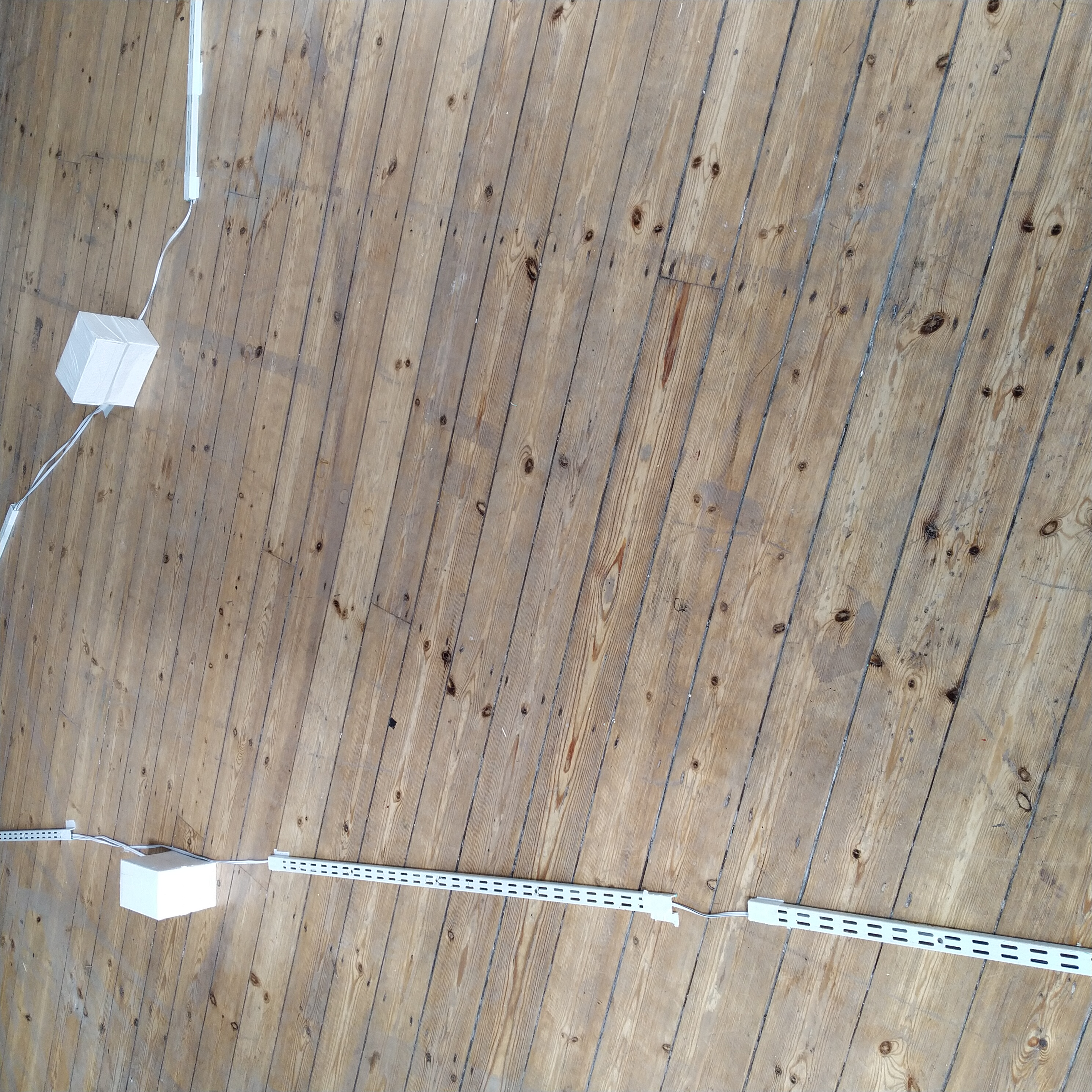 A closer installation view of some transducer boxes on the floor of the Constellation sound installation.