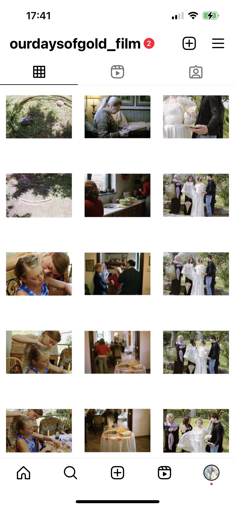 Instagram grid shows a sequence of images combining domestic, outdoor, and ritual-like scenes:
Top row: two tortoises inside a circular enclosure on grass; an older woman seated indoors looking at photographs; a close-up of hands holding an object while wearing a white dress.
Second row: the same tortoise enclosure from another angle; two women working in a kitchen; four people outdoors surrounding someone in a white dress, holding paintings and covered objects.
Third row: a close-up of two women, one leaning her head against the other; a man and woman seen through a doorway conversing; the same group outside again with the white dress.
Fourth row: a woman touching another woman's hair indoors at a dining table; a blurred view of people in a hallway; a close-up of a round table with two wrapped packages.
Bottom row: another image of the hair-touching scene; a similar shot of the round table; and the outdoor group with the woman in the white dress viewed from another angle.