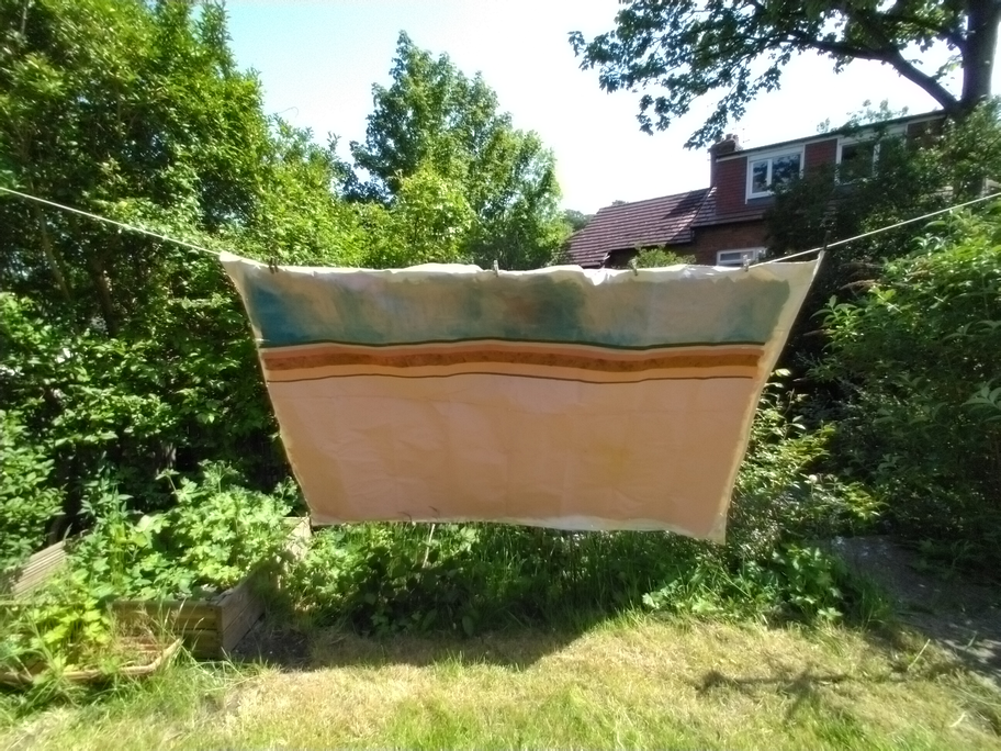 Image shows the full painting previously depicted as a detail. However now the painting is presented in a distorted perspective due to its context of being hung on a washing line to dry.