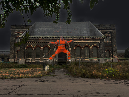 the figure of a person performing tai chi in hi-vis workwear on the facade of a Victorian building